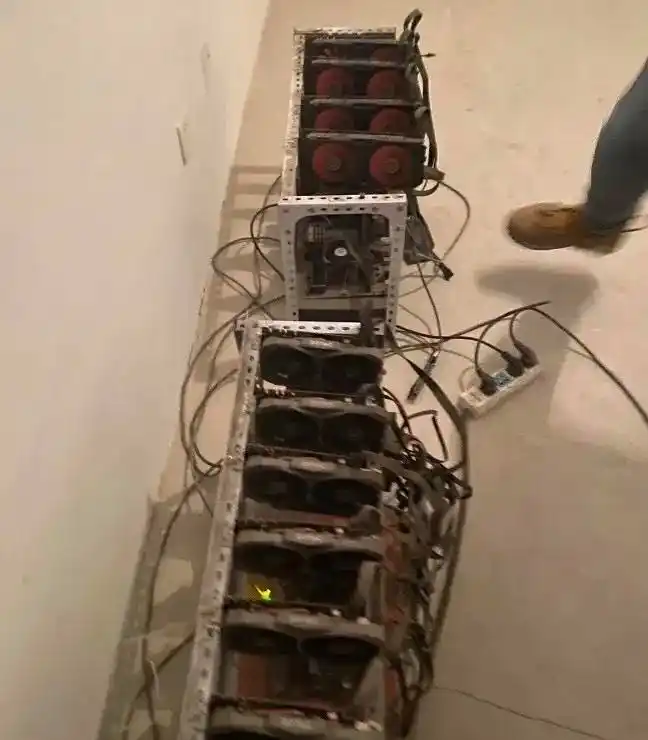 A close-up of a worker inspecting a mining rig in a data center